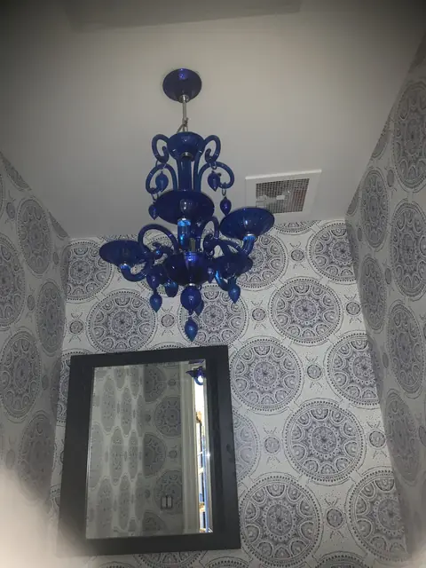 Blue glass chandelier in a powder room