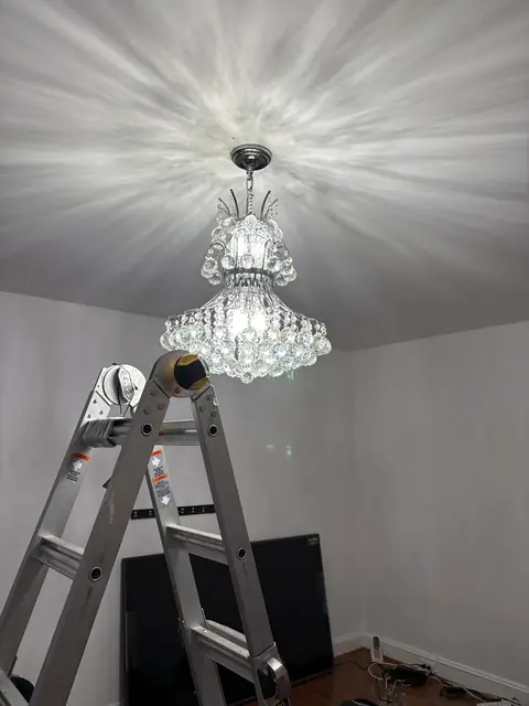 Crystal chandelier, mid-install