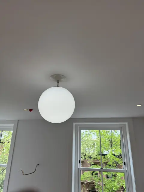 Globe pendant by a garden window