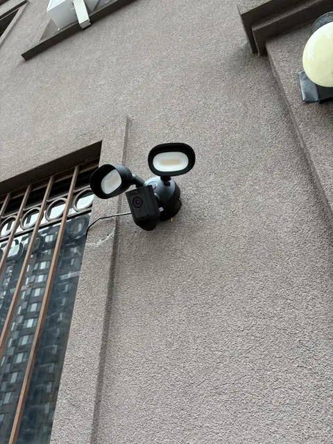 Floodlight camera on an exterior wall