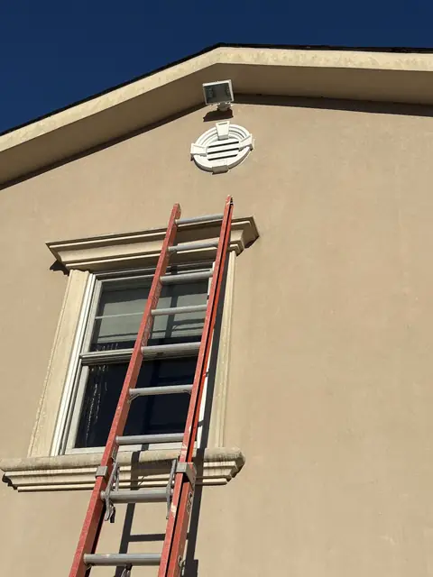 Exterior fixture install on a two-story house