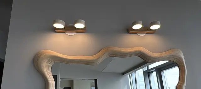 Vanity lights over a curved mirror