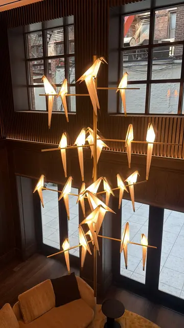 Sculptural bird chandelier in a double-height lounge